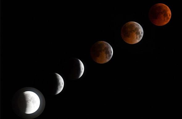 Montagem com seis fotos mostra a evolução do eclipse parcial ao total com Lua de Sangue de 2018./ Foto: Vyacheslav Oseledko/AFP